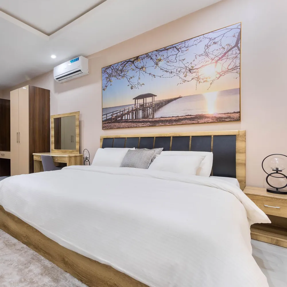 Master bedroom at MJ's Haven Lekki with a king bed and pier artwork