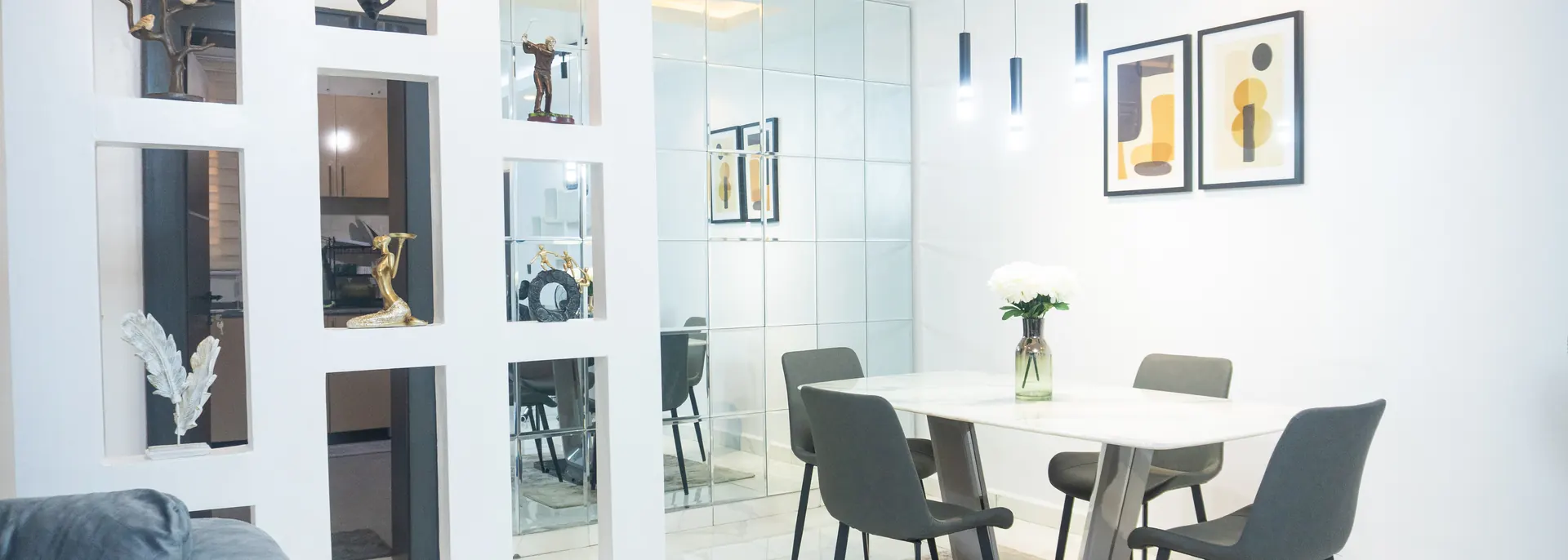 Dining area at MJ's Haven Garki with a marble table and pendant lighting